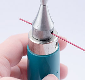Putting wire through the hole in the mandrel